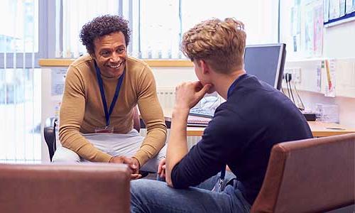 A student speaking to an admission counselor